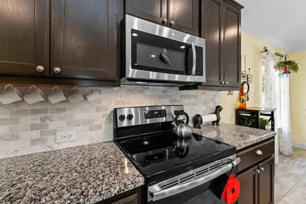 a kitchen with a stove and a microwave