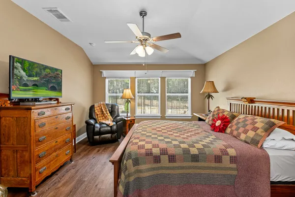 a bedroom with a bed and a flat screen tv