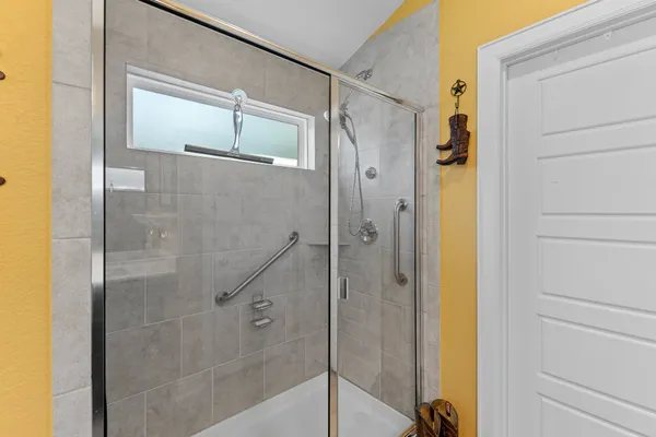 a bathroom with a shower and a sink