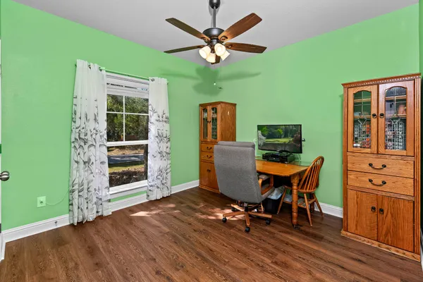 a view of a workspace with furniture and a window