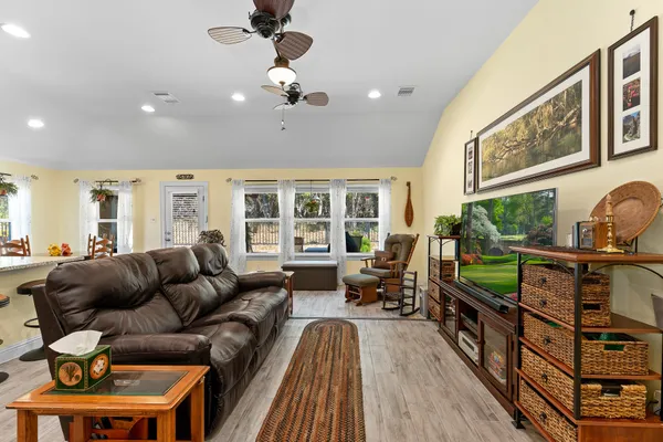 a living room with furniture and a floor to ceiling window