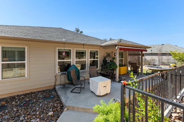 a view of a chair and tables in the patio