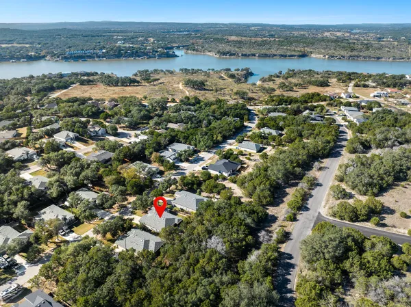 an aerial view of a house with a yard and balcony