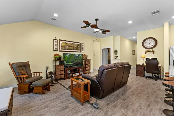 a living room with furniture and wooden floor
