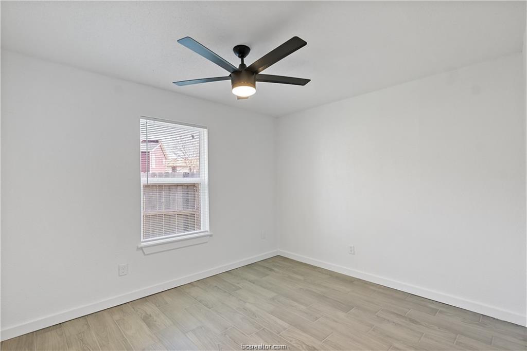 1503 Alpine Circle, Unit B College Station, TX 77840 - Photo 13 of 15 an empty room with wooden floor and windows
