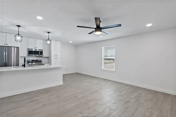 a view of kitchen with stainless steel appliances refrigerator oven and stove