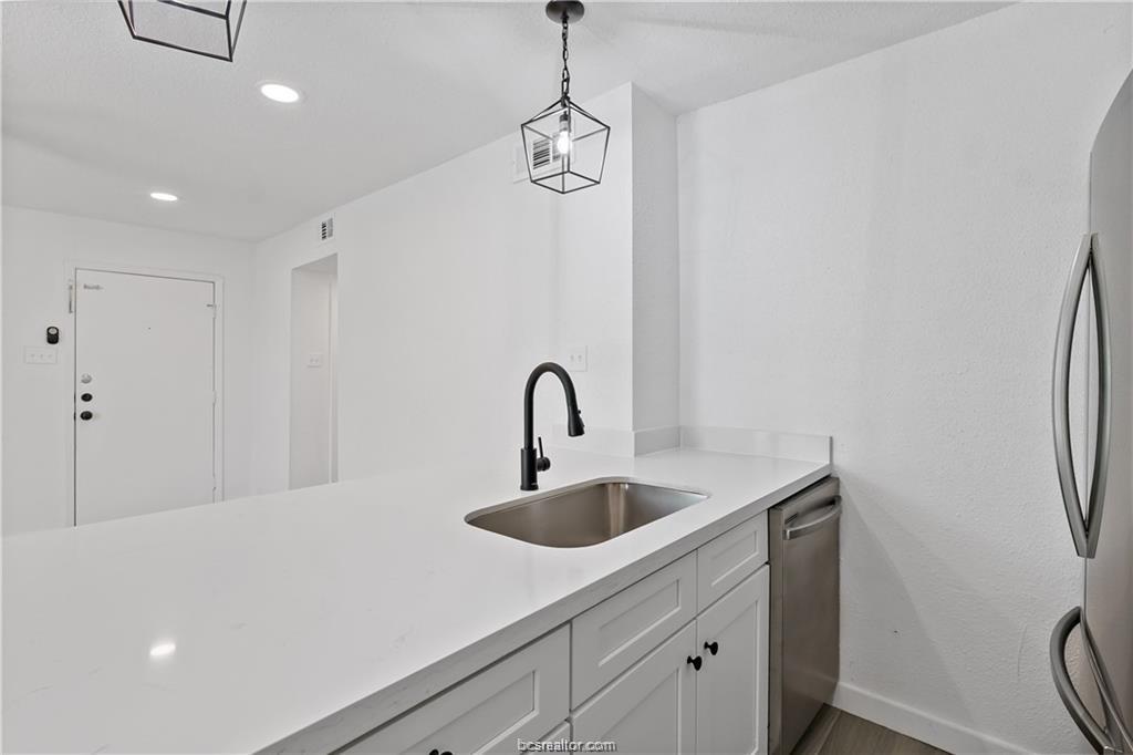 1503 Alpine Circle, Unit B College Station, TX 77840 - Photo 9 of 15 a kitchen with a sink and a refrigerator