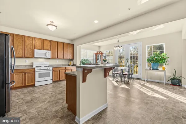 a kitchen with granite countertop a sink stainless steel appliances and cabinets
