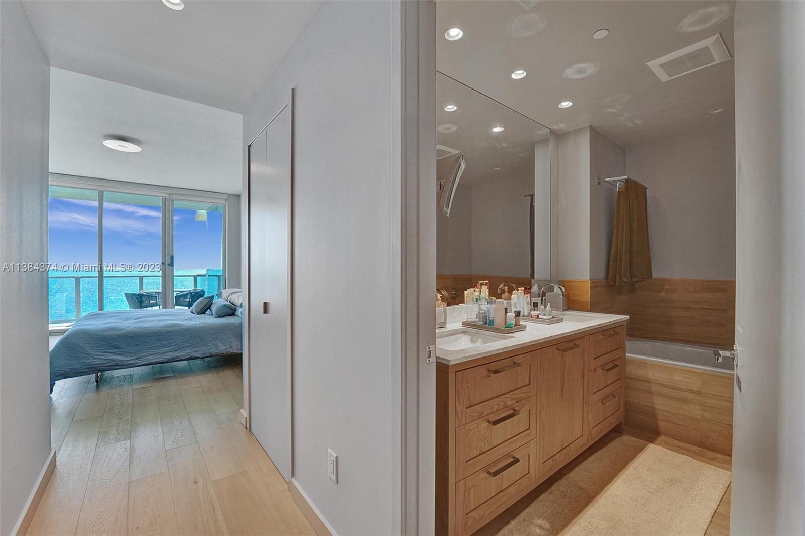 360 Ocean Drive, Unit 906S Key Biscayne, FL 33149 - Photo 14 of 33 a bathroom with a double vanity sink and mirror