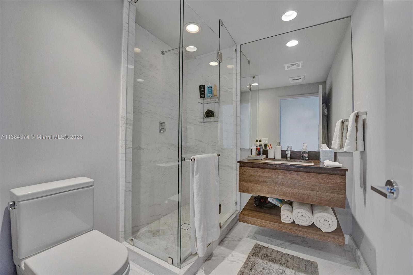 360 Ocean Drive, Unit 906S Key Biscayne, FL 33149 - Photo 21 of 33 a bathroom with a toilet sink and shower