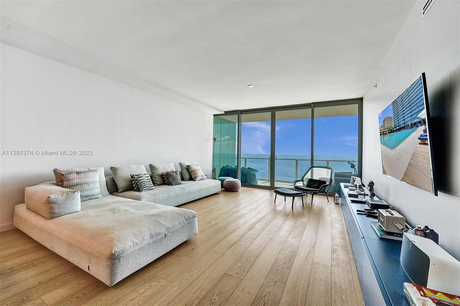360 Ocean Drive, Unit 906S Key Biscayne, FL 33149 - Photo 26 of 33 a living room with furniture and a flat screen tv
