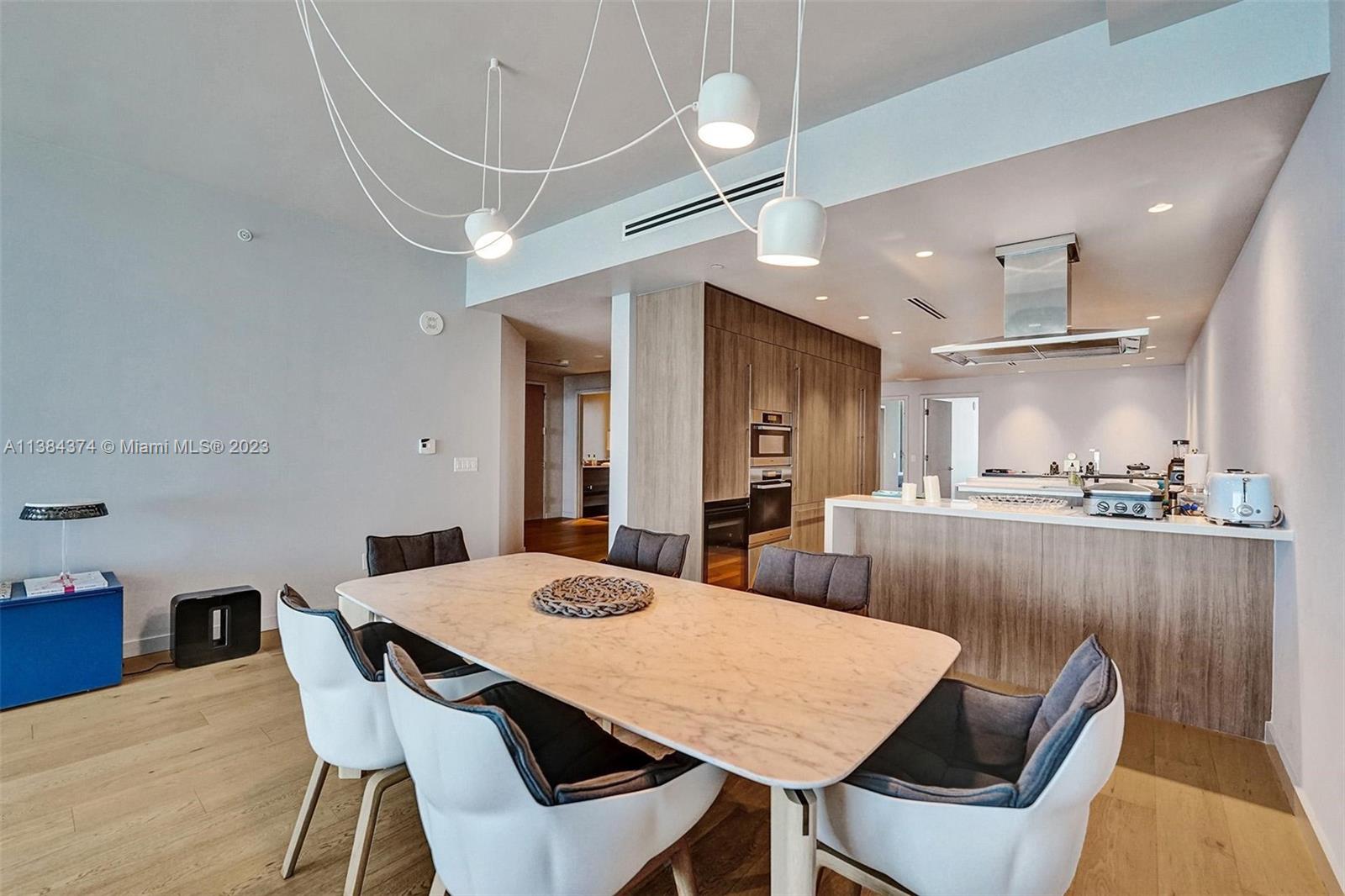 360 Ocean Drive, Unit 906S Key Biscayne, FL 33149 - Photo 8 of 33 a view of a dining room with furniture and wooden floor
