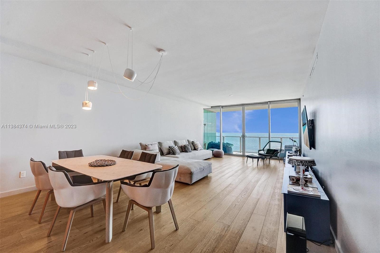 360 Ocean Drive, Unit 906S Key Biscayne, FL 33149 - Photo 9 of 33 a view of a dining room with furniture a rug and wooden floor