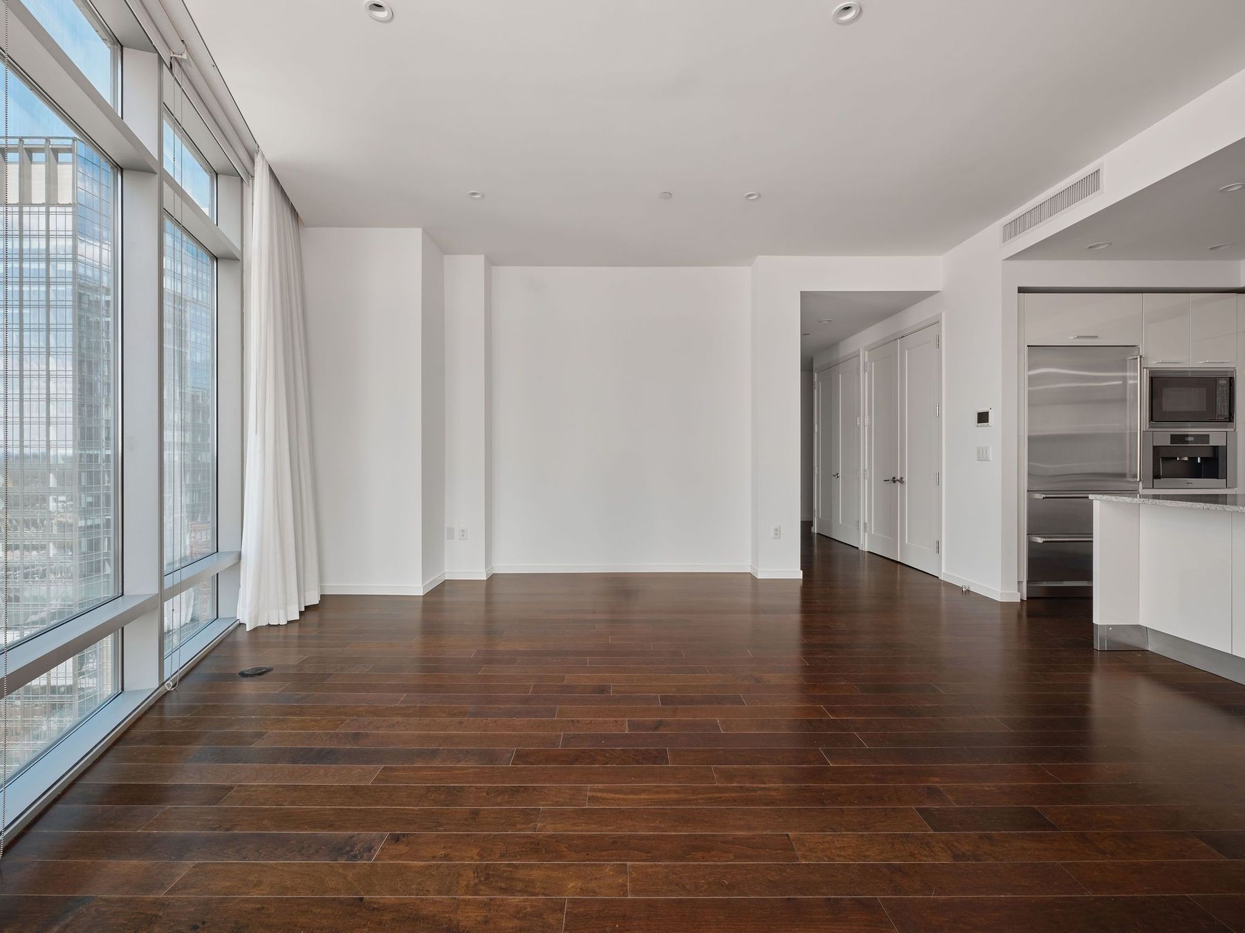 200 Congress Avenue, Unit 23C Austin, TX 78701 - Photo 17 of 40 a view of an empty room with wooden floor and a window