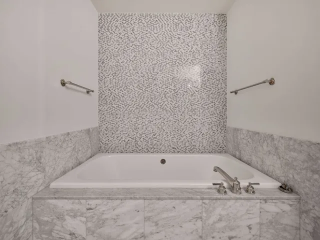 a bathroom with a granite countertop sink mirror and shower