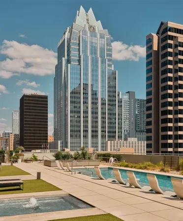 a view of a white building with a swimming pool