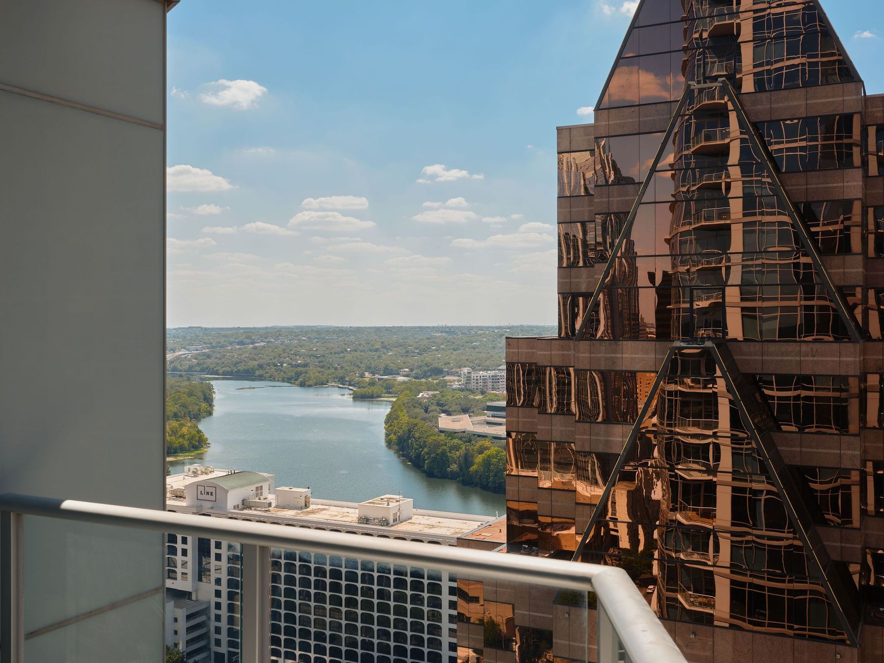200 Congress Avenue, Unit 23C Austin, TX 78701 - Photo 4 of 40 a roof deck with tall buildings and ocean view