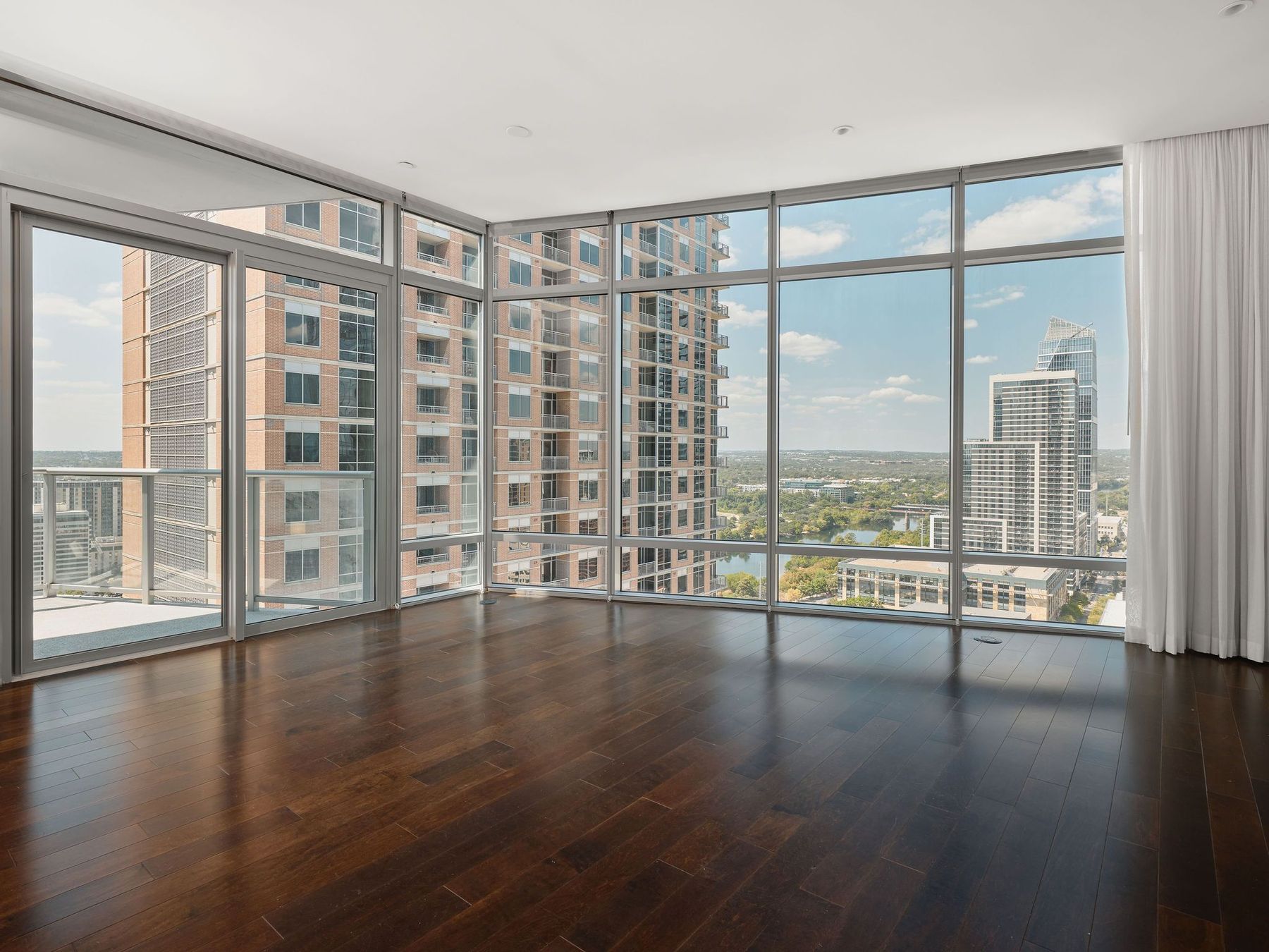 200 Congress Avenue, Unit 23C Austin, TX 78701 - Photo 7 of 40 a view of an empty room with wooden floor and a window