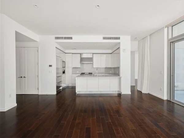 a view of kitchen with refrigerator and wooden floor