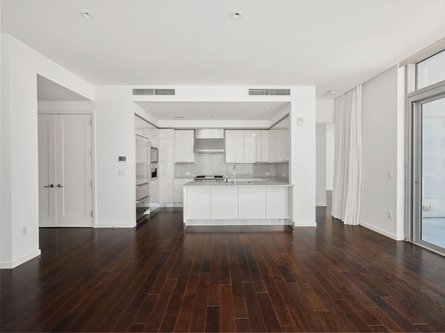 200 Congress Avenue, Unit 23C Austin, TX 78701 - Photo 8 of 40 a view of kitchen with refrigerator and wooden floor