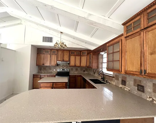 a view of a bedroom with a ceiling fan and a window