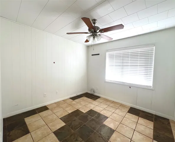a bathroom with a granite countertop toilet a sink and a window