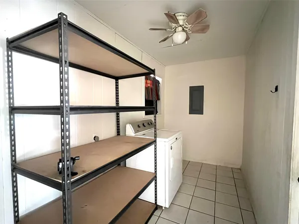 a living room with furniture and floor to ceiling windows