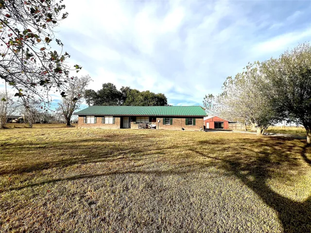 a view of a yard with wooden fence