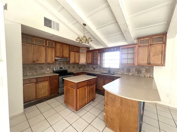 a kitchen with stainless steel appliances granite countertop a sink stove and cabinets