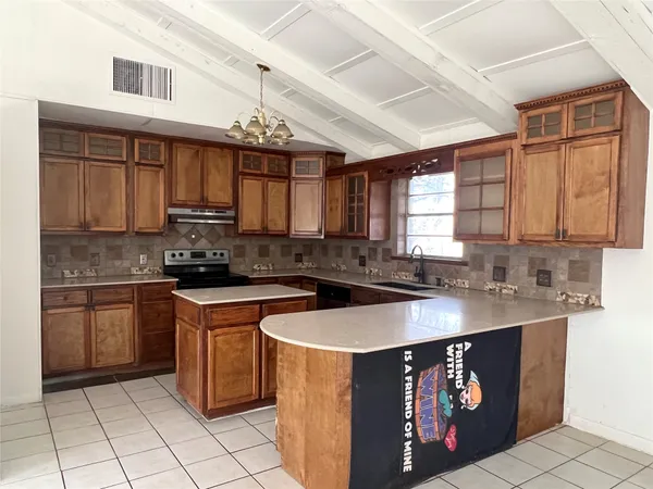 a kitchen with stainless steel appliances granite countertop a sink window and cabinets
