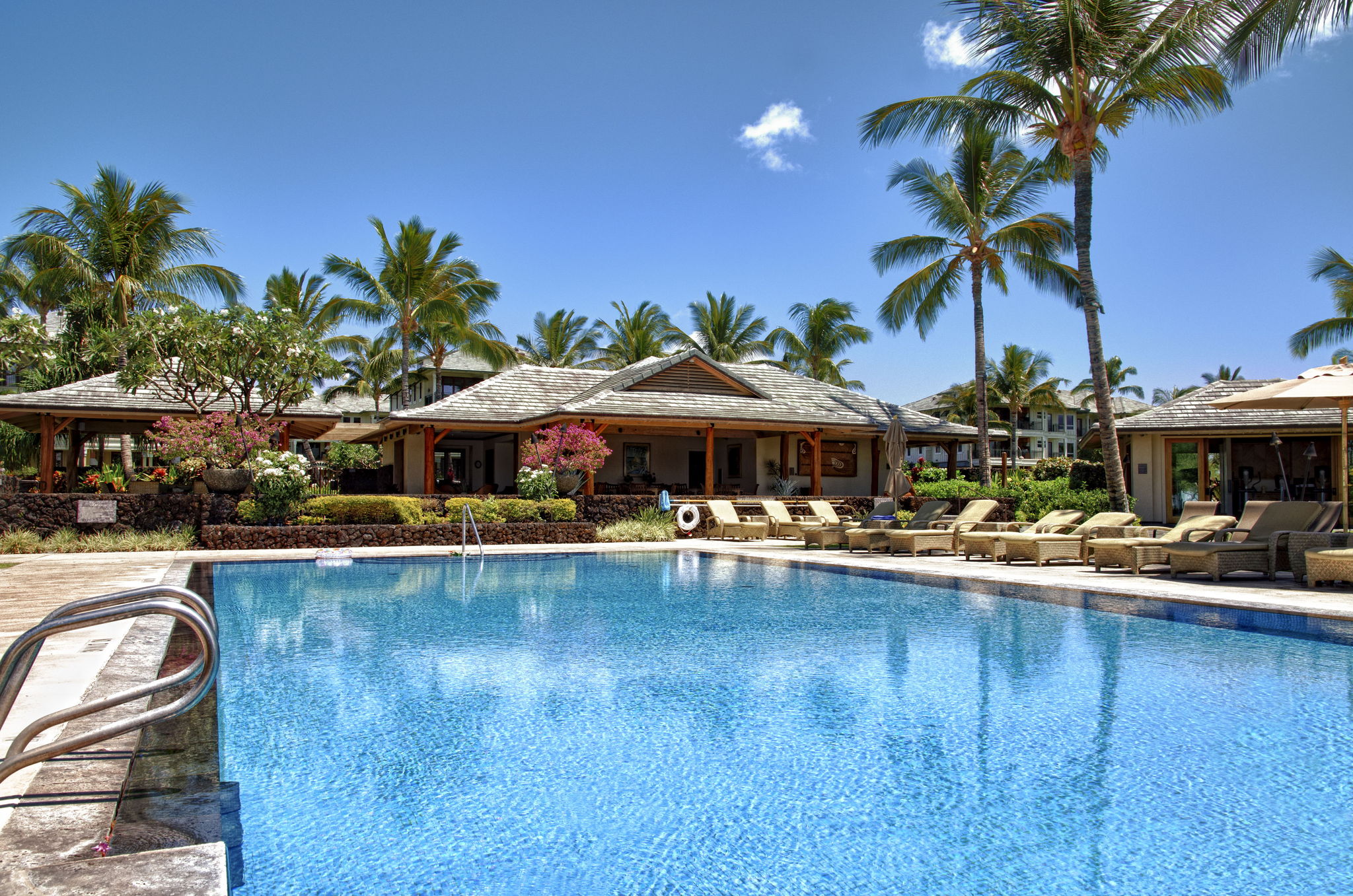 69-1000 Kolea Kai Circle, Unit 16J Waikoloa, HI 96738 - Photo 22 of 25 a view of swimming pool with lawn chairs under an umbrella