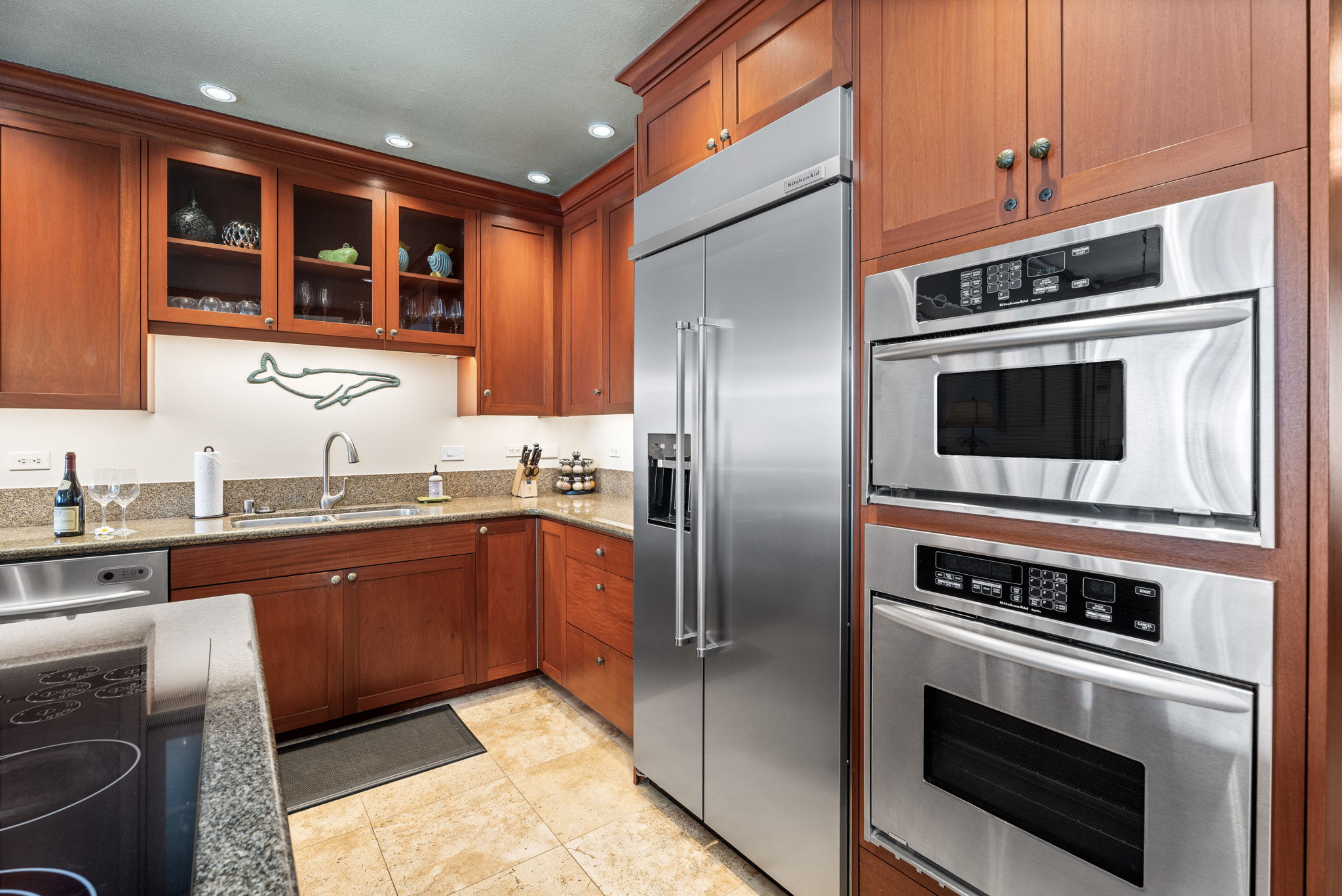 69-1000 Kolea Kai Circle, Unit 16J Waikoloa, HI 96738 - Photo 6 of 25 a kitchen with stainless steel appliances granite countertop a stove microwave and refrigerator