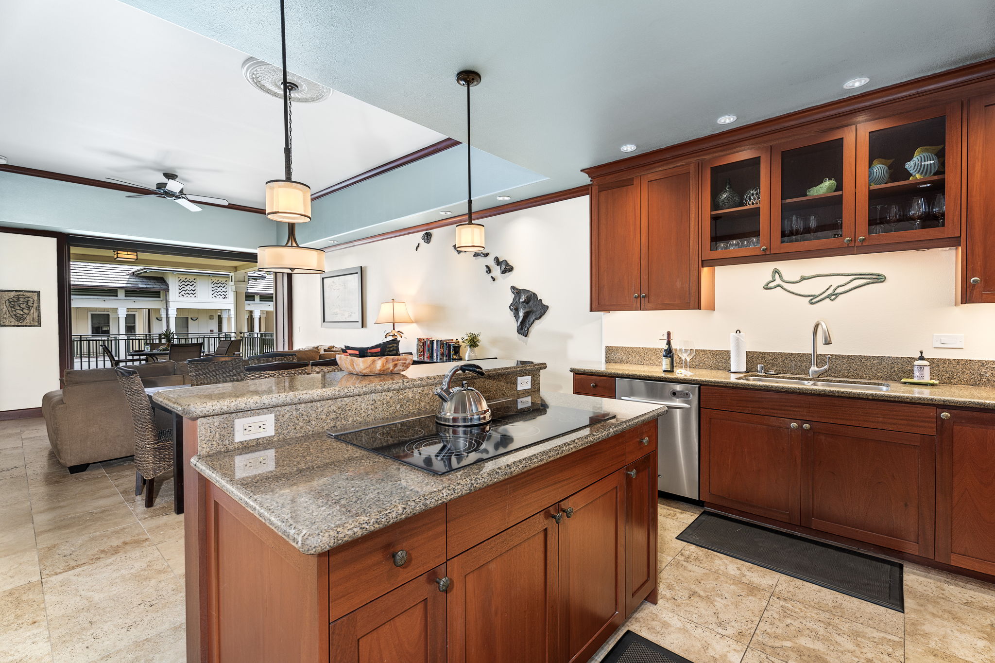 69-1000 Kolea Kai Circle, Unit 16J Waikoloa, HI 96738 - Photo 7 of 25 a kitchen with stainless steel appliances granite countertop a sink and a wooden cabinets