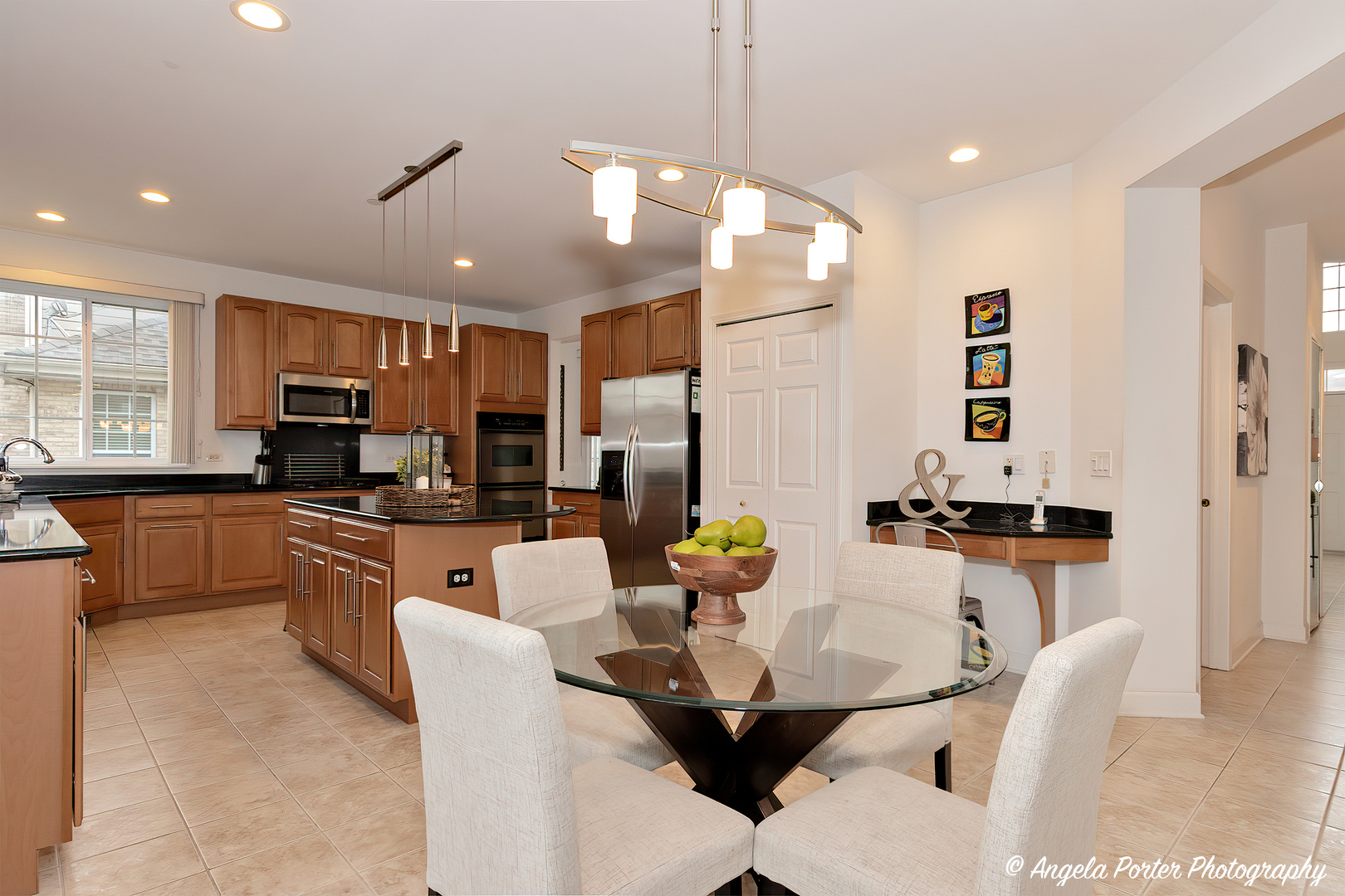 1340 Horizon Trail Wheeling, IL 60090 - Photo 11 of 27 a kitchen with stainless steel appliances granite countertop a stove top oven a sink a dining table and chairs with wooden floor
