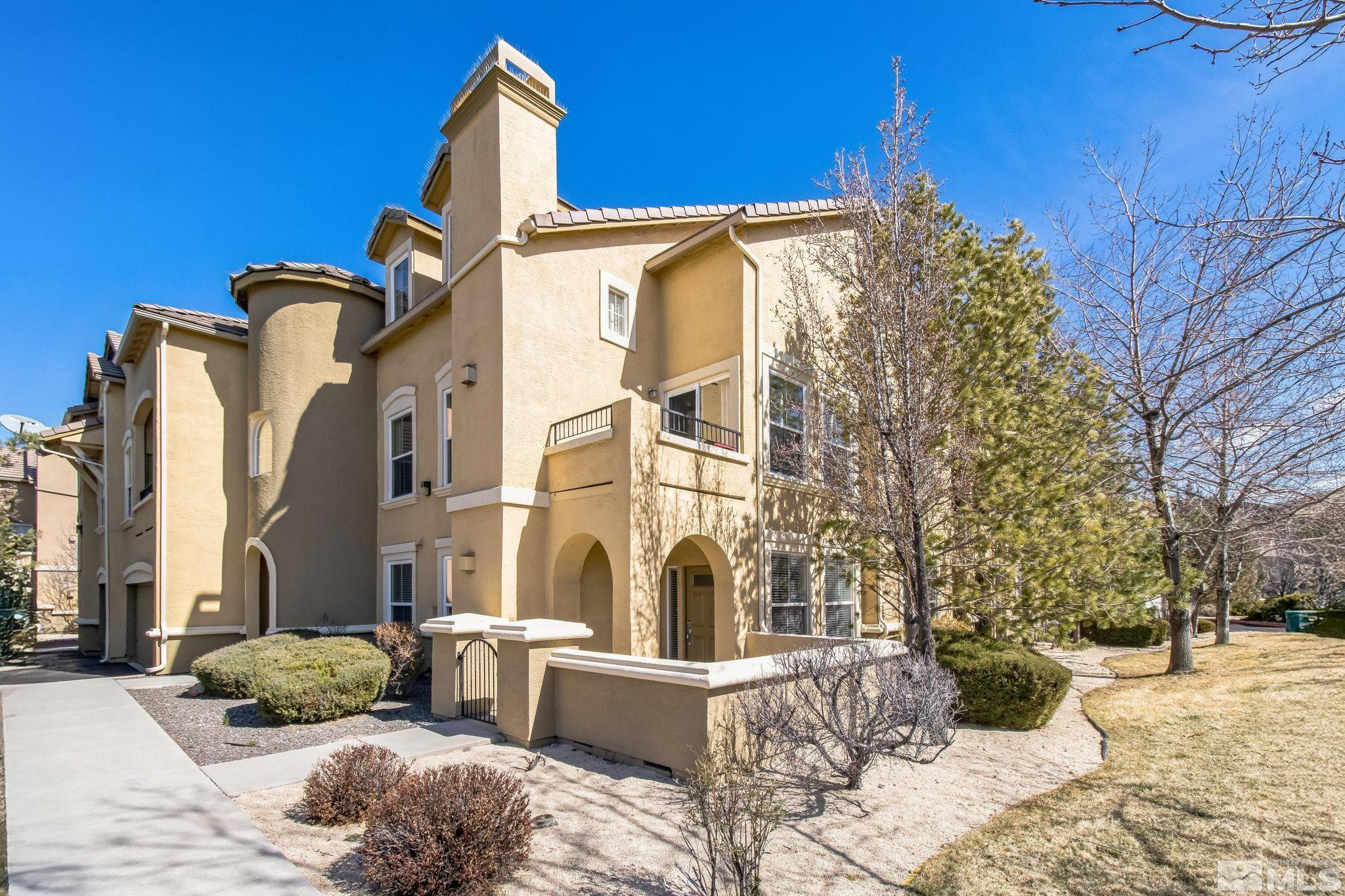 9050 Double R Boulevard, Unit 1412 Reno, NV 89521 - Photo 1 of 18 front view of a house with a yard