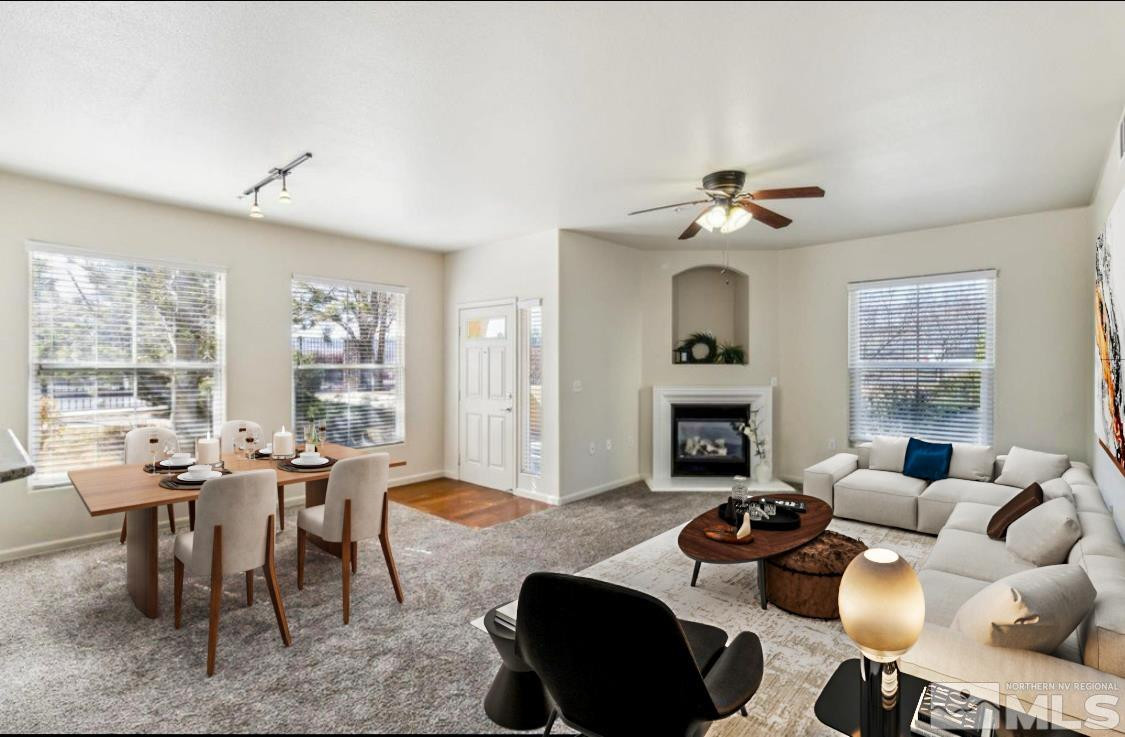 9050 Double R Boulevard, Unit 1412 Reno, NV 89521 - Photo 3 of 18 a living room with furniture a fireplace and windows