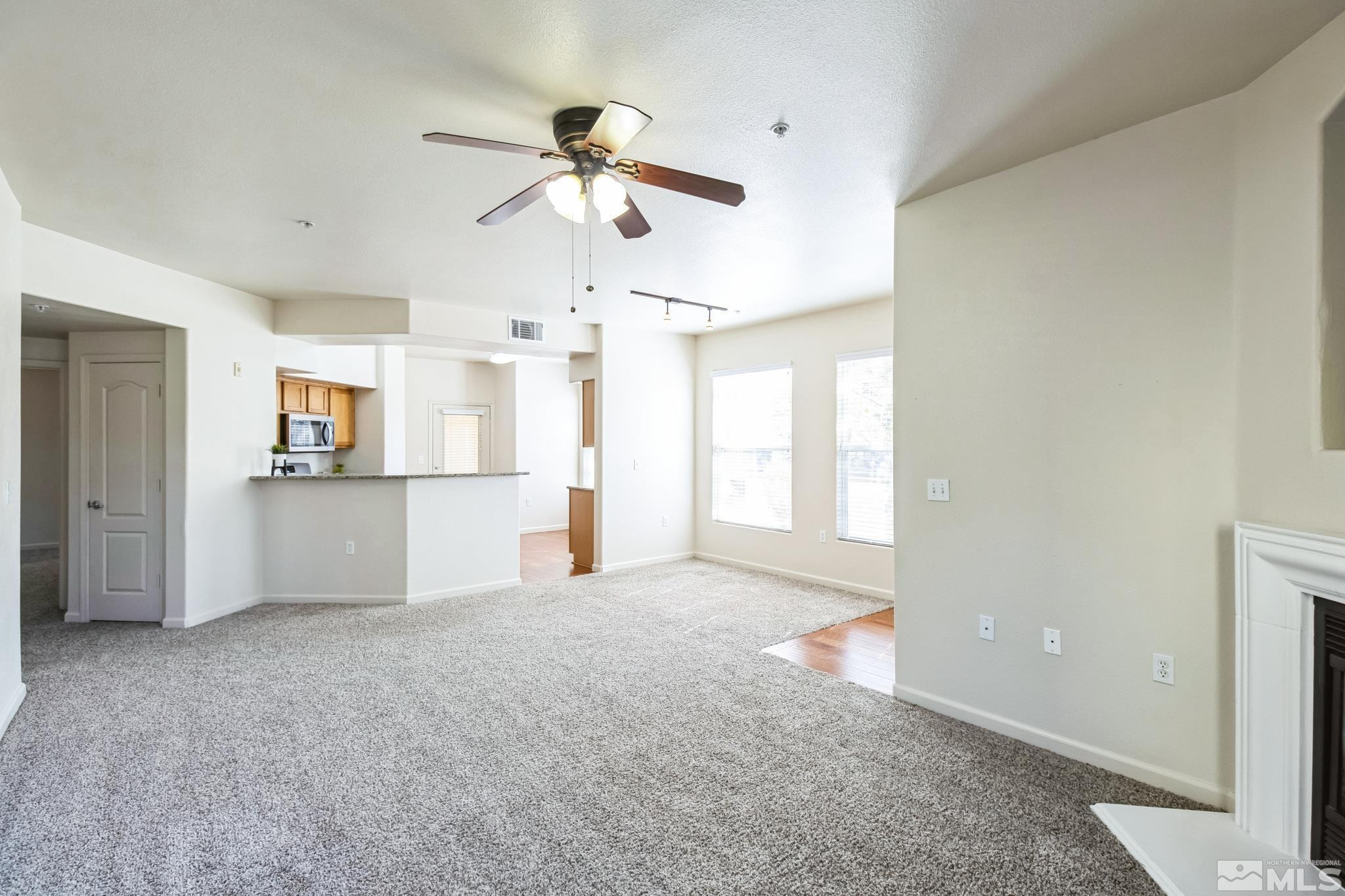 9050 Double R Boulevard, Unit 1412 Reno, NV 89521 - Photo 4 of 18 en empty room with windows and ceiling fan