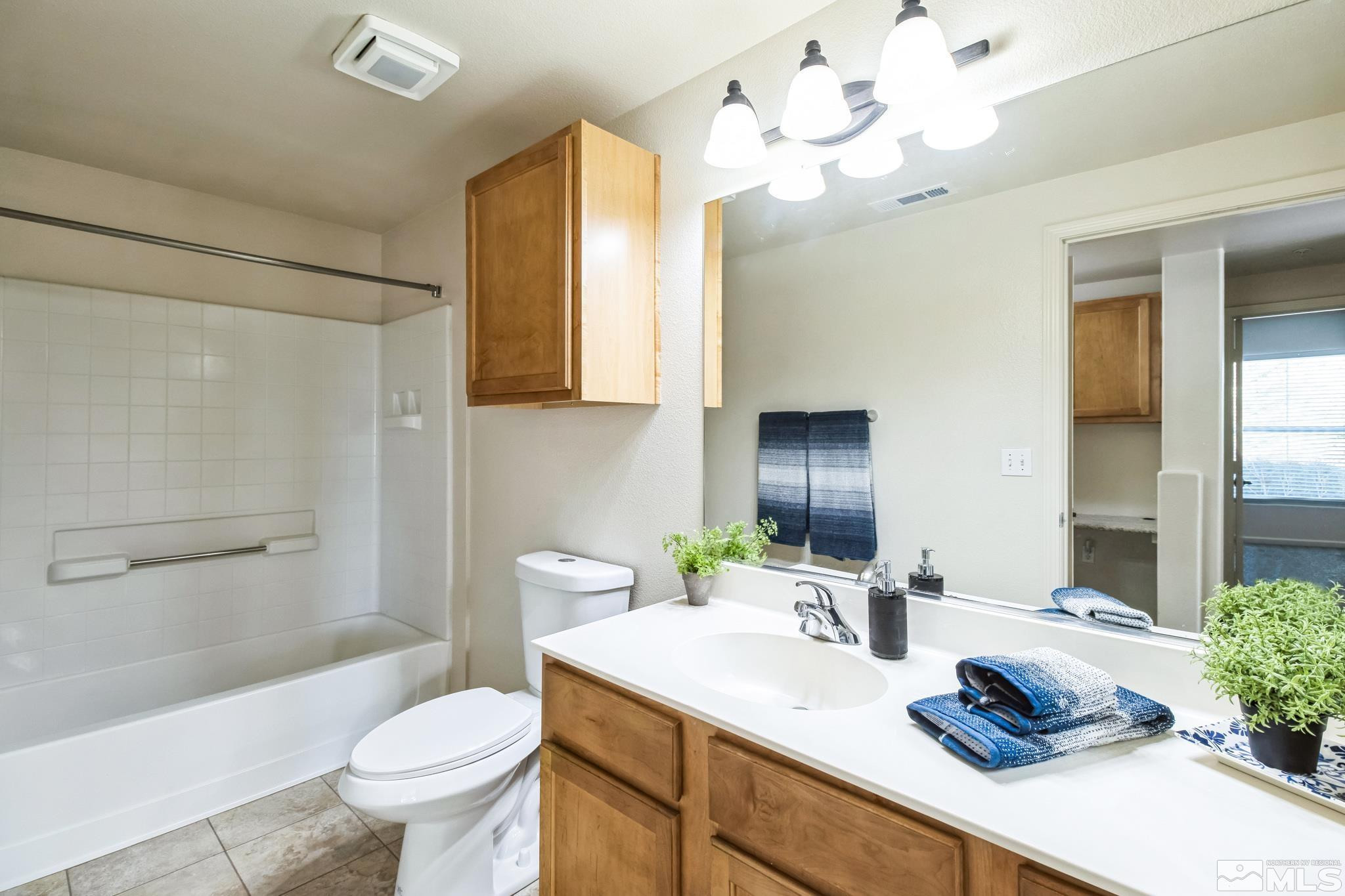 9050 Double R Boulevard, Unit 1412 Reno, NV 89521 - Photo 10 of 18 a bathroom with a sink a toilet and shower