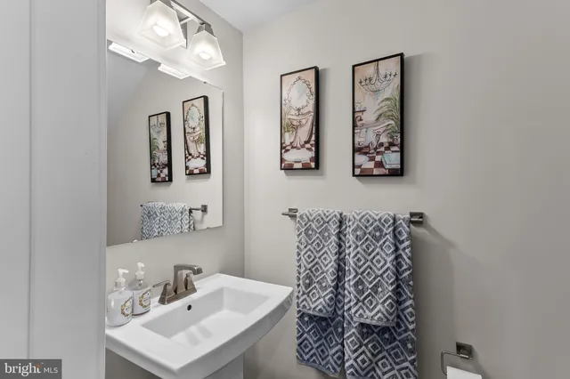 a bathroom with a sink a mirror and a toilet