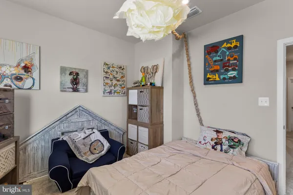 a living room with furniture a clock on wall and a window