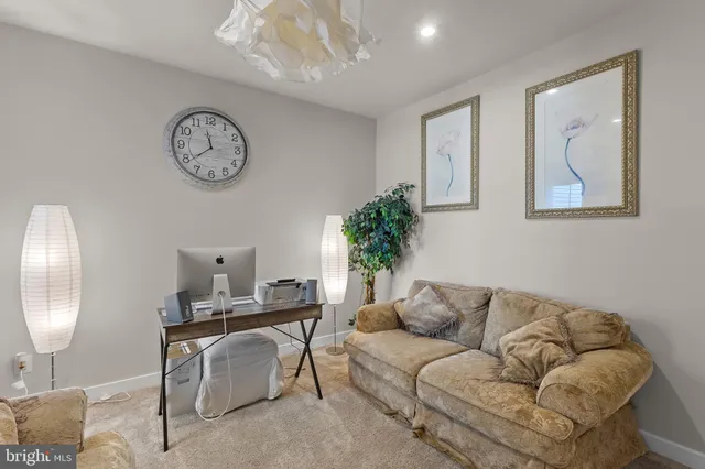 a bedroom with furniture and a flat screen tv