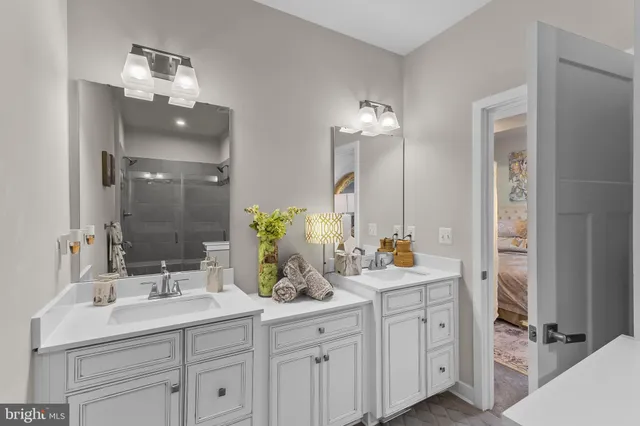 a bathroom with double sink and a mirror