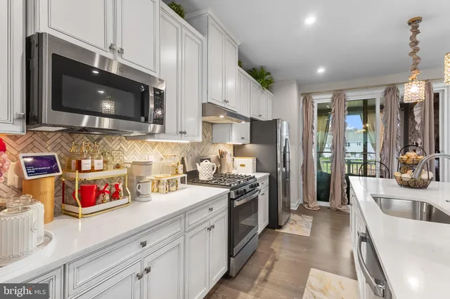 a living room with furniture and a large window with bookshelf