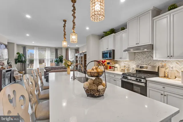 a kitchen with sink a stove and cabinets