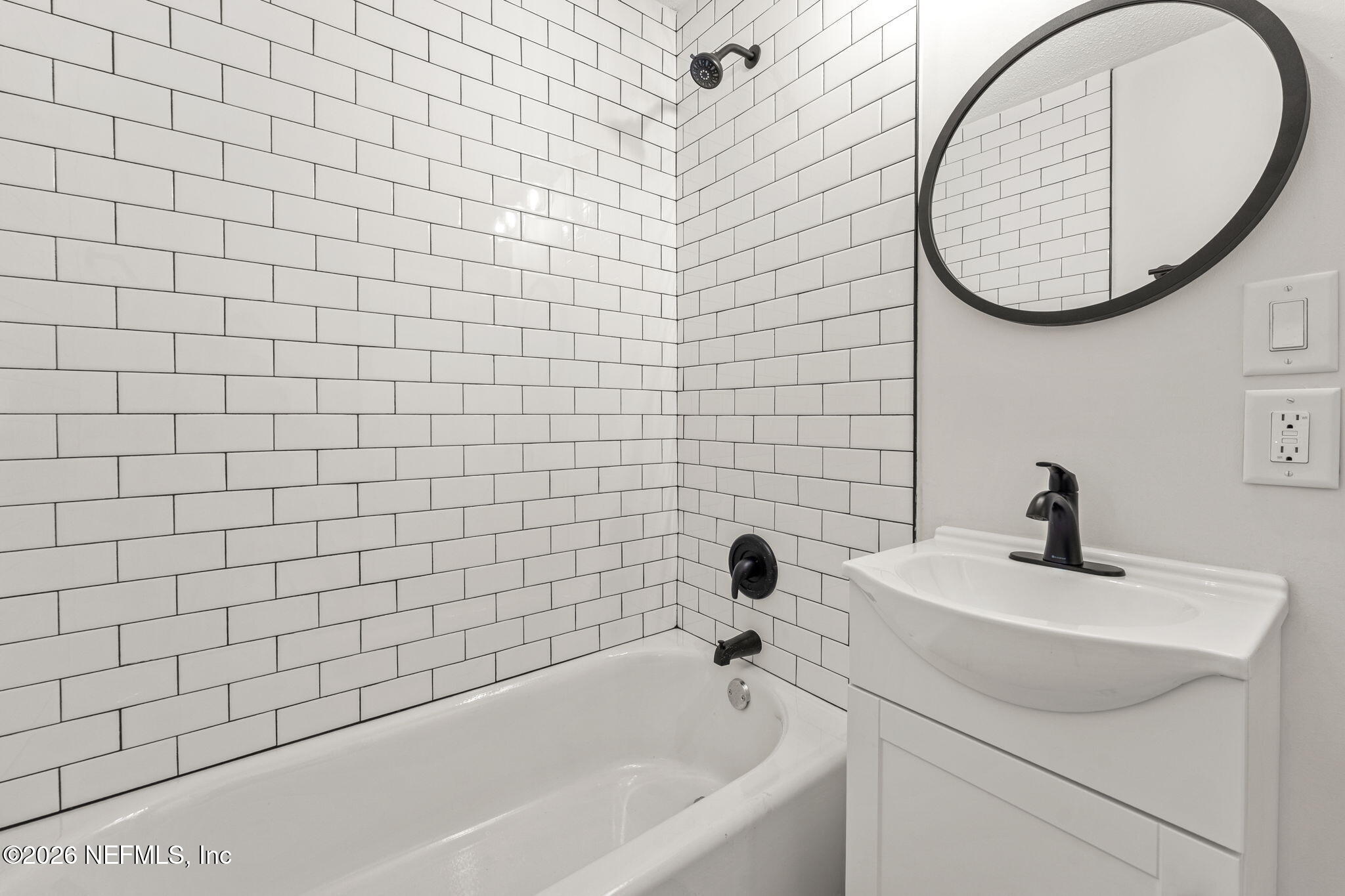 87 Josiah Street St. Augustine, FL 32084 - Photo 18 of 19 a bathroom with a sink a toilet and a bathtub
