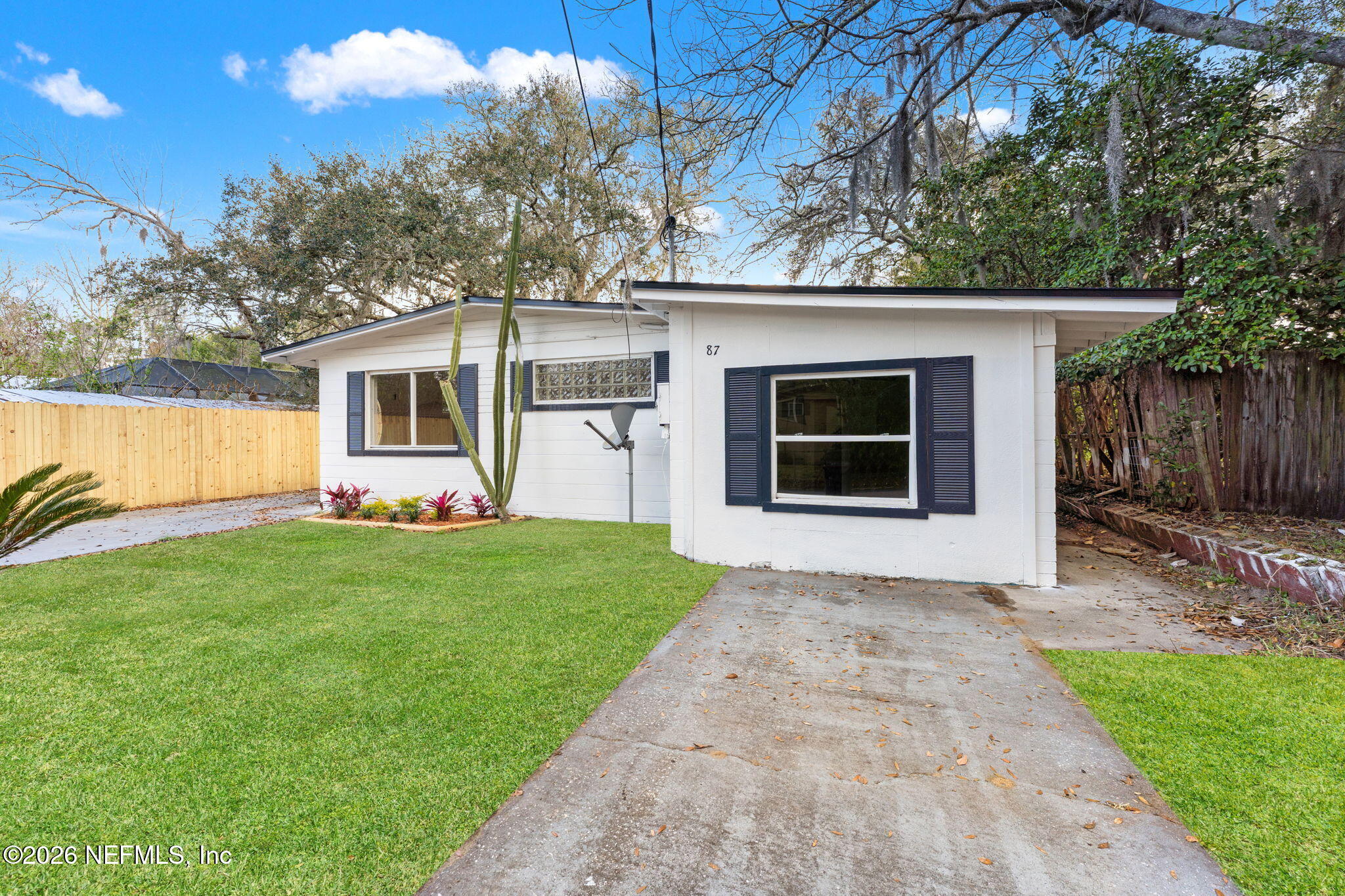 87 Josiah Street St. Augustine, FL 32084 - Photo 2 of 19 a front view of a house with garden and a tree