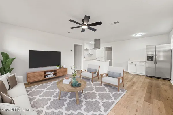 a living room with furniture and a flat screen tv