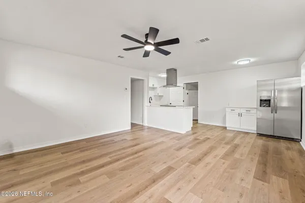 a view of a kitchen with a sink and a refrigerator