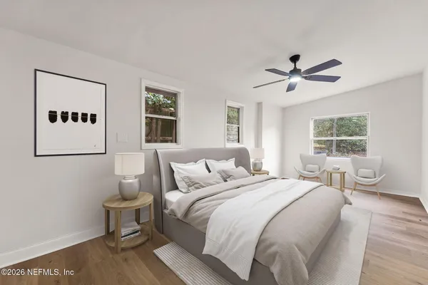 a bedroom with a bed and a painting on the wall
