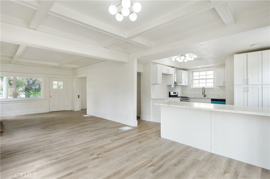 4415 12th Street Riverside, CA 92501 - Photo 12 of 33 a view of a kitchen with kitchen island a sink wooden floor and a large window